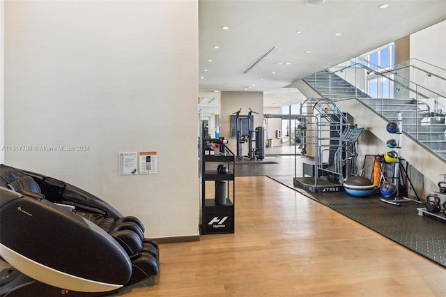 workout room with light hardwood / wood-style flooring