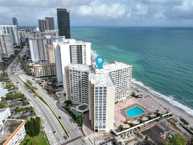 birds eye view of property with a view of the beach and a water view