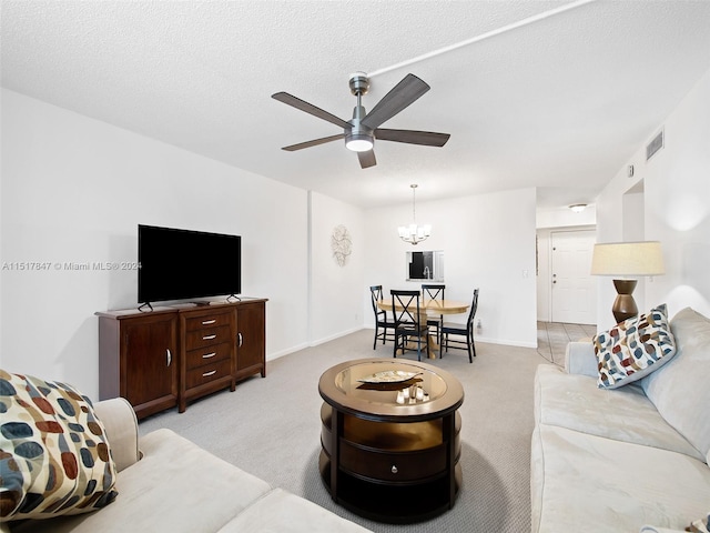 carpeted dining room featuring ceiling fan with notable chandelier