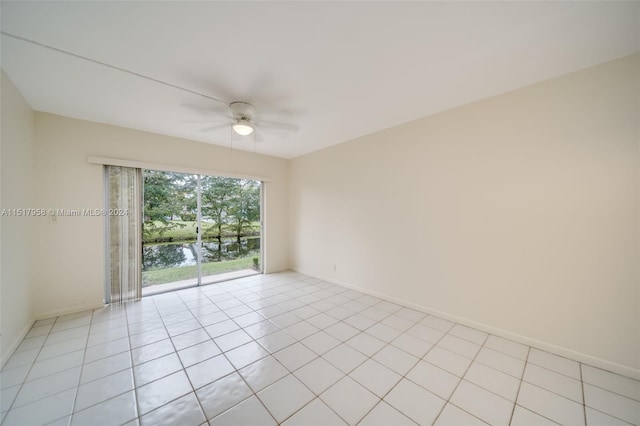 tiled empty room featuring ceiling fan