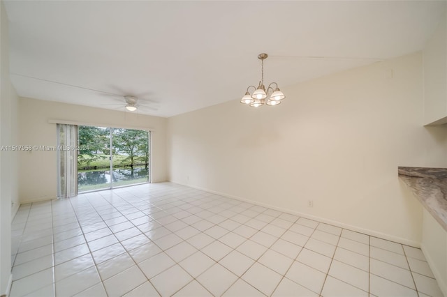 unfurnished room featuring light tile floors and ceiling fan with notable chandelier