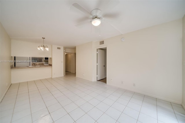 unfurnished living room featuring light tile floors and ceiling fan with notable chandelier