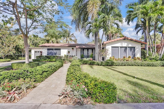 mediterranean / spanish-style house featuring a front yard