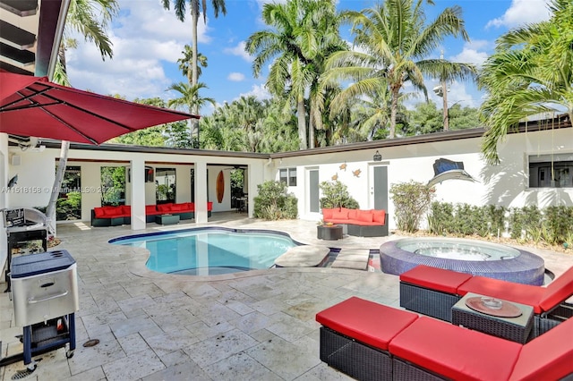 view of pool with a patio, an in ground hot tub, and an outdoor living space