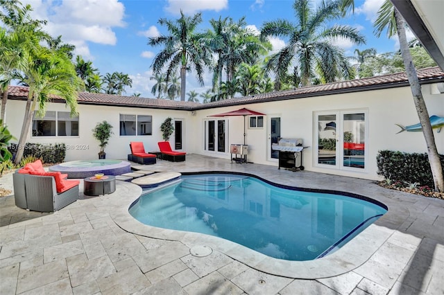 view of swimming pool with french doors, an outdoor hot tub, and a patio