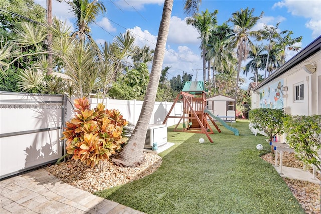 view of yard with an outdoor structure and a playground