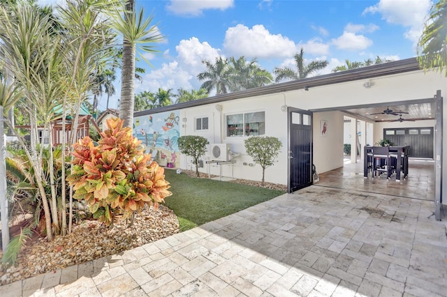 view of front of property featuring ceiling fan and a patio