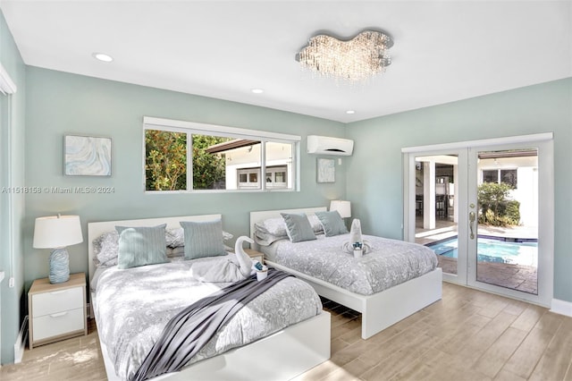 bedroom featuring access to outside, multiple windows, french doors, and a wall unit AC