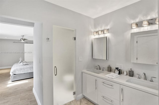 bathroom featuring double vanity, wood-type flooring, and ceiling fan