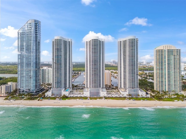 property's view of city with a water view and a beach view