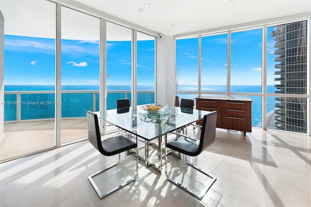 sunroom / solarium with a water view