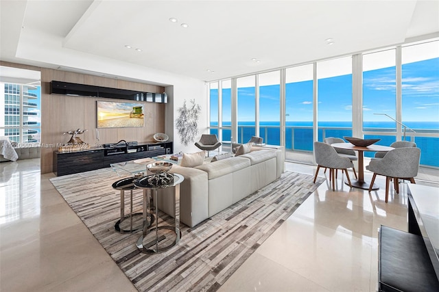 living room with a water view and floor to ceiling windows