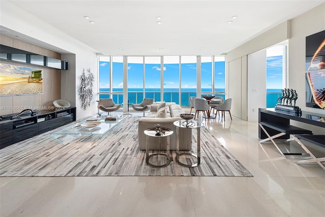 living room featuring a water view and floor to ceiling windows