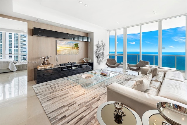 living room featuring a water view and light tile floors