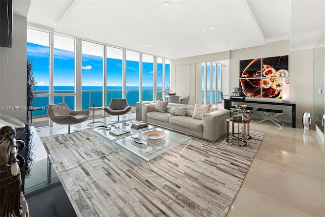 living room featuring a water view and a wall of windows