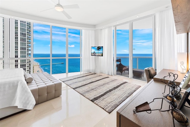 bedroom featuring a water view and ceiling fan