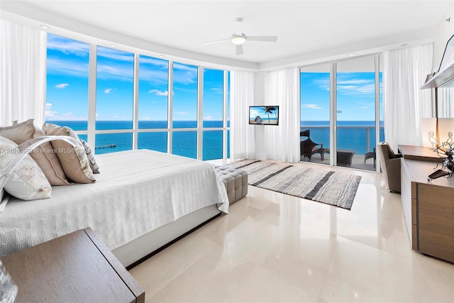 tiled bedroom featuring a water view and ceiling fan