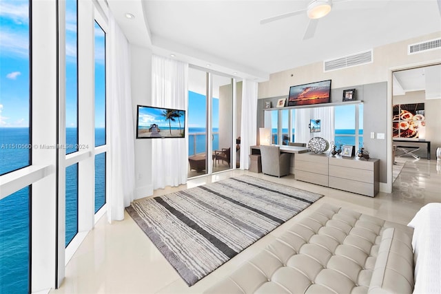 interior space featuring ceiling fan and a water view