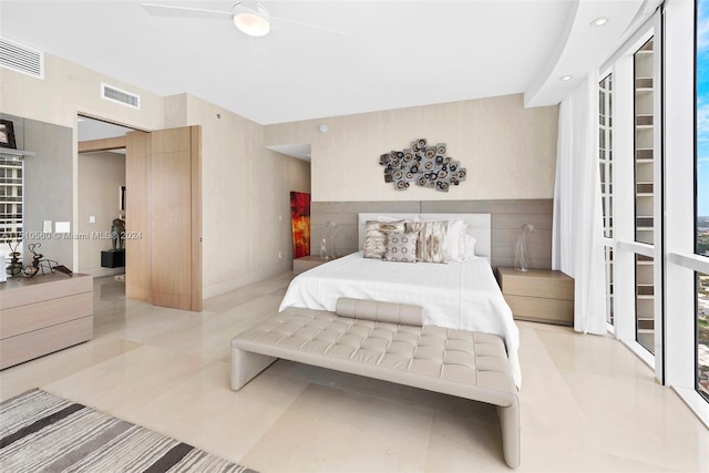 bedroom featuring ceiling fan and light tile floors