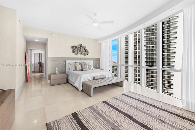 tiled bedroom featuring ceiling fan