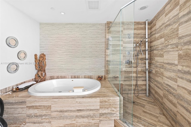 bathroom with shower with separate bathtub