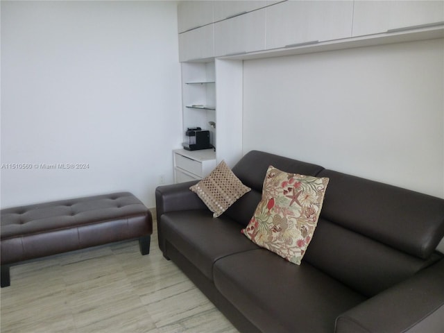 living room featuring built in features and light wood-type flooring