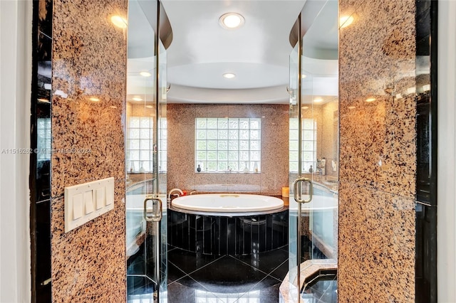 bathroom featuring separate shower and tub and tile walls