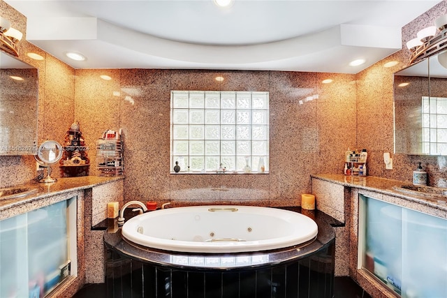 bathroom with vanity, tile walls, and a wealth of natural light