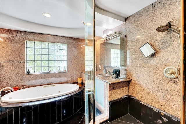 bathroom featuring tile patterned floors, plus walk in shower, vanity, and tile walls