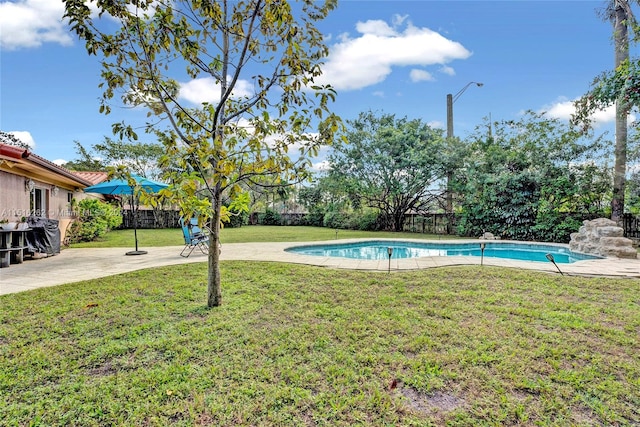 view of pool featuring a yard and a patio