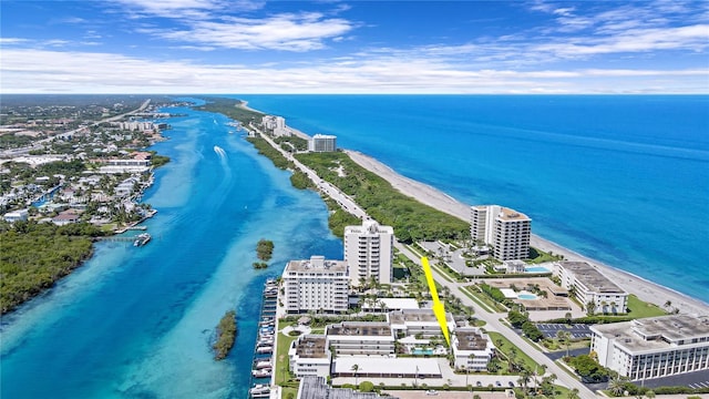 drone / aerial view with a beach view and a water view