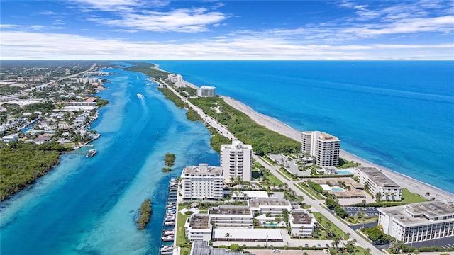 birds eye view of property featuring a water view and a beach view