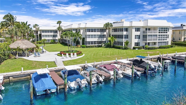 exterior space with a water view and a lawn