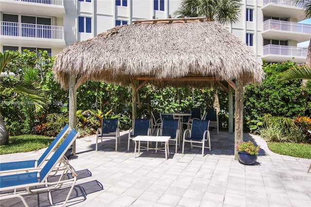 view of patio / terrace with a balcony and a gazebo