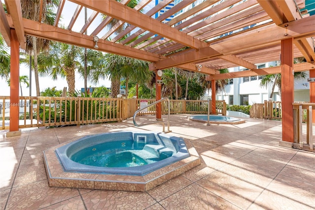 view of pool featuring a community hot tub, a pergola, and a patio area