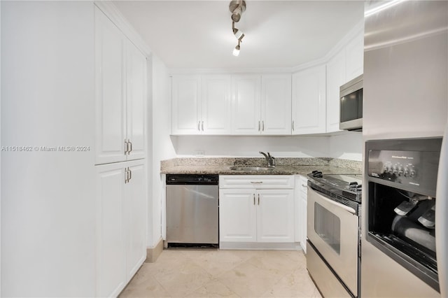 kitchen featuring sink, white cabinets, and appliances with stainless steel finishes