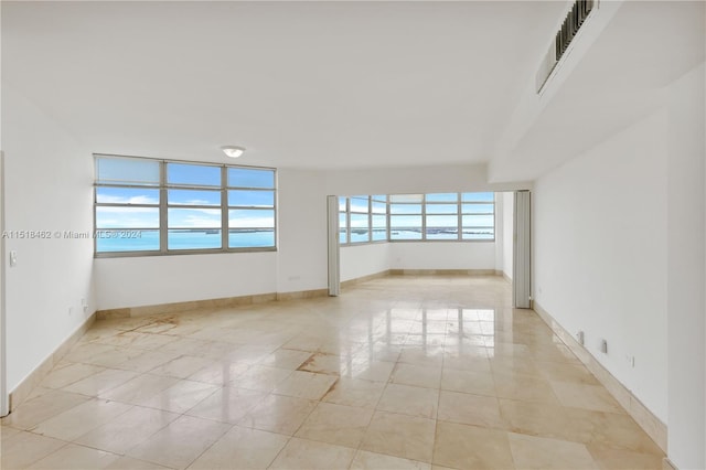 unfurnished room featuring light tile patterned floors