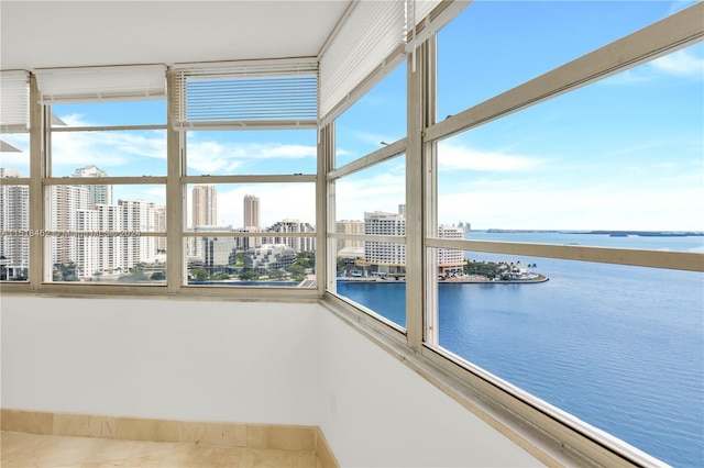 unfurnished sunroom featuring a water view