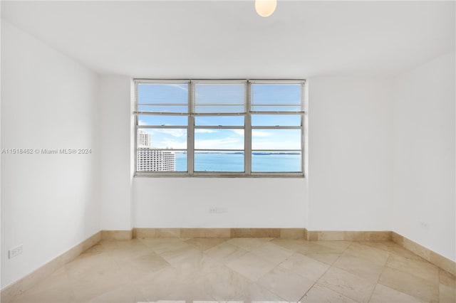 empty room featuring a water view