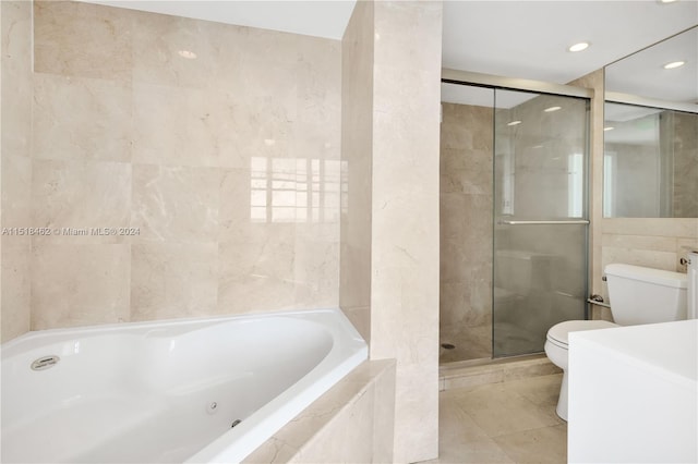 bathroom featuring tile patterned floors, separate shower and tub, toilet, and tile walls