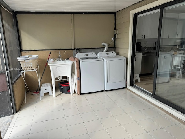 washroom with light tile floors and washing machine and clothes dryer