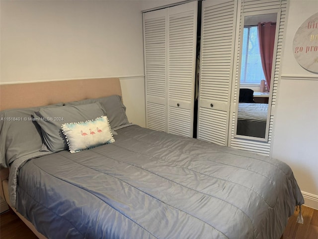 bedroom with a closet and dark hardwood / wood-style flooring