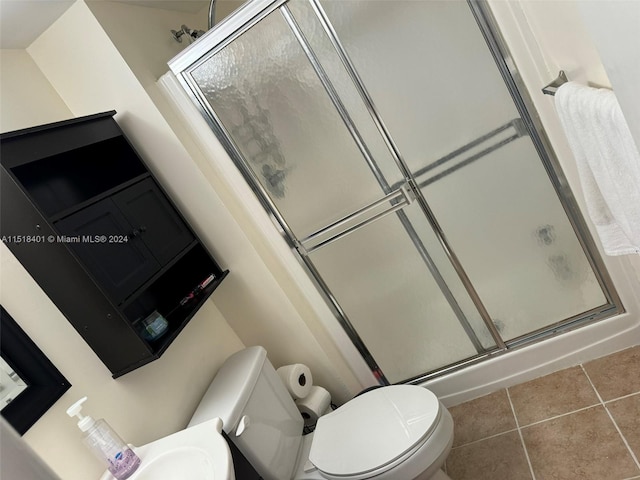 bathroom with vanity, walk in shower, tile floors, and toilet