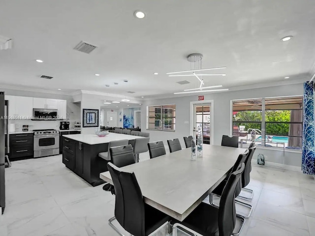 dining space with light tile flooring, french doors, and crown molding