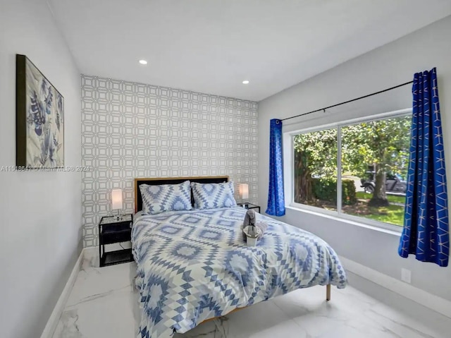 bedroom featuring tile flooring and multiple windows