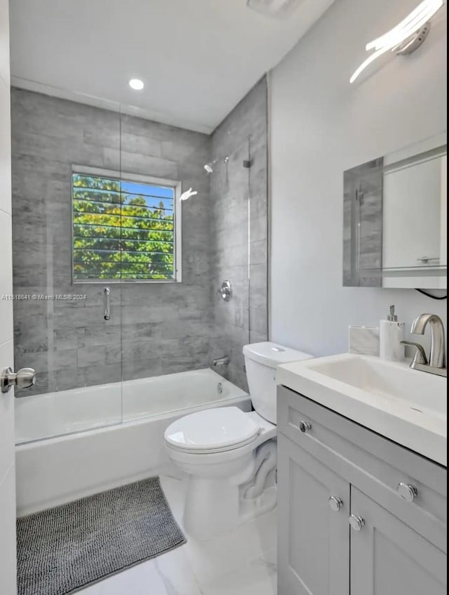 full bathroom with toilet, tile floors, bath / shower combo with glass door, and vanity