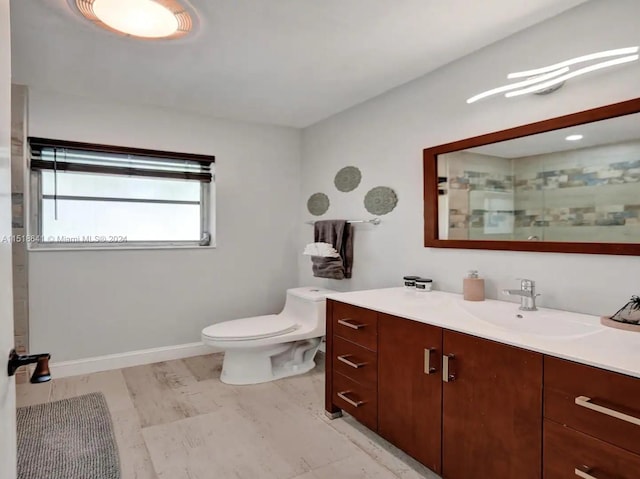 bathroom featuring vanity, tile floors, and toilet