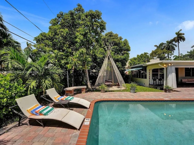 view of swimming pool with a patio