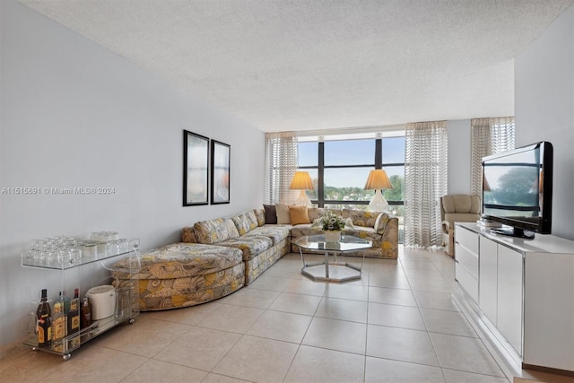 tiled living room with a wall of windows and a textured ceiling