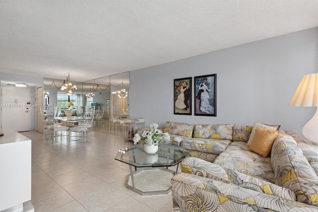 tiled living room featuring a chandelier and a textured ceiling